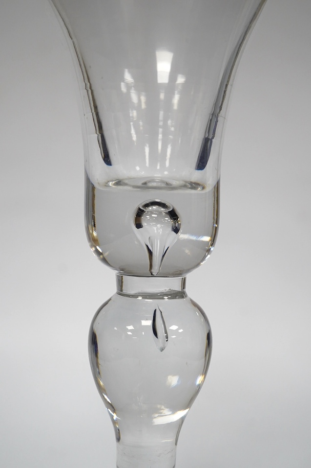 A baluster wine glass, c.1730, the bell shaped bowl with basal tear, inverted baluster stem, conical foot, 15.6cm high. Condition - good